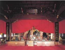 Statuen weißer Füchse stehen neben dem Altar zum Toyokawa Dakini Shinten.